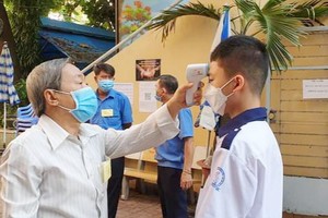 老師為考生測量體溫。