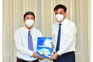 市人委會副主席黎和平（右）向黎晉強同志頒授《決定》。（圖源：越勇）