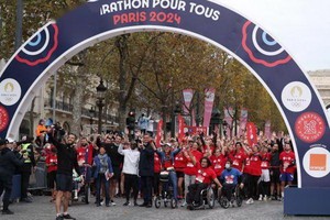 基普喬格、巴黎奧組委主席埃斯坦蓋（前左一）等與參賽選手在賽前自拍。（圖源: 互聯網）