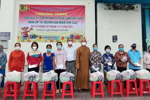 郡祖國陣線委員會副主席梅洪峰與釋慧功法師向第十坊同胞贈送禮物。