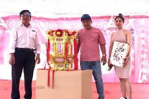 楊梓進（左）向“福燈”得主阮昇平夫婦移交聖燈。