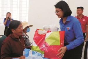 共青团本市市委副书记陈秋霞探望和向古芝县优抚政策家庭赠送礼物。 