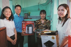 平盛郡劳动联团和赞助商代表向苏氏芳（右二）赠送炊具。