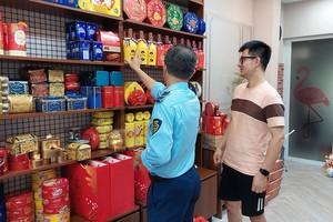 4号市场管理队正检查阮国榕街G.H经营户经营点。（图：国林）