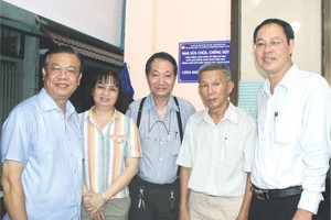 市越南祖国阵线委员会常务副主席阮成忠（右一）、庆云南院住持周华邦（中）移交“温情屋”工程。