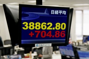 屏幕显示东京股市日经指数一度较昨日收盘上涨超过700点，站上38800点，逼近历史最高位。（图：共同社）