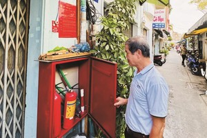  第一郡范伍老坊第五街区区长丁春誉检查联家组的消防器材柜。