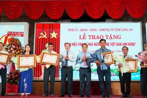 隆安省领导向越南英雄母亲家属颁赠国家荣誉称号。（图：隆安报）