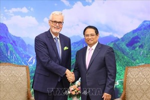 政府总理范明政（右）会见前来拜别的德国驻越南大使吉多·希尔德纳。（图：越通社）