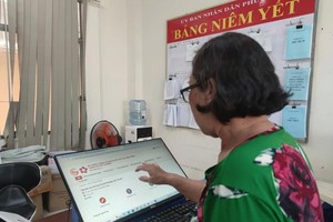 民众在旧邑郡第五坊人委会办理线上服务登记手续。