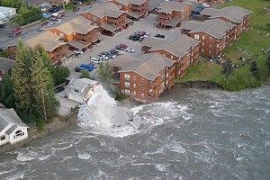 阿拉斯加门登霍尔冰川融化，朱诺市（Juneau）一栋地基几乎消失的房屋，在滚滚洪流中应声倒塌。（图：路透社）