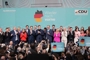 在德国柏林的基督教民主联盟总部，联盟党总理候选人默茨(中)在出口民调显示领先后接受祝贺。（图：新华社）