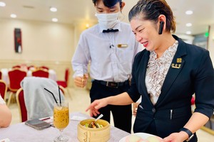 爱华2酒楼员工向食客介绍新推出的点心。