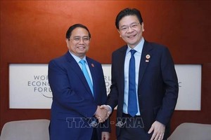 越南政府总理范明政会见新加坡总理黄循财。（图：越通社)