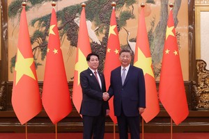 中共中央总书记、国家主席习近平迎接国家主席梁强。图自越通社