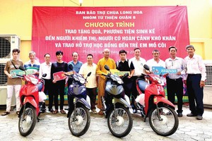 龙华寺住持释慧功和尚与护法会同仁向贫困户赠送谋生工具。