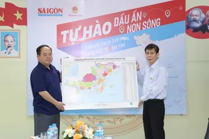 Đồng chí Nguyễn Khắc Văn, Quyền Tổng Biên tập Báo Sài Gòn Giải Phóng trao tặng bản đồ tỉnh Quảng Ninh tới đồng chí Quản Minh Cường, Ủy viên Ban Chấp hành Trung ương Đảng, Bí thư Tỉnh ủy, Trưởng Đoàn đại biểu Quốc hội tỉnh Quảng Ninh, chiều 22-4. Ảnh: QUANG PHÚC