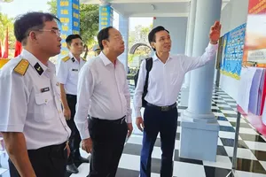 胡志明市人民议会常务副主席阮文寿（中）在129号海团考察提前投票点。