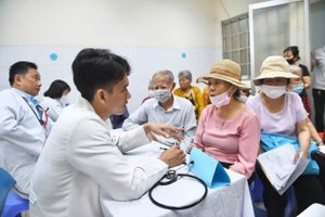 医生在桔莱坊医疗站为高龄患者进行检查与咨询。图：字忠