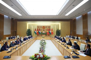 政府总理范明政会见约旦众议院议长。 图自越通社 