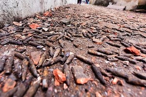 A road is full with bullet warheads after the explosion in Quan Do hamlet
