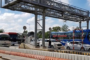 Vehicles travel through Soc Trang BOT toll station