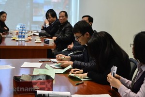 Participants at an auction of State-owned shares held by the HNX (Photo: VNA)