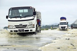 Vehicles drive through floodwater on a highway near Kyauktaw township in Myanmar's Rakhine state (Source: www.mmtimes.com)
