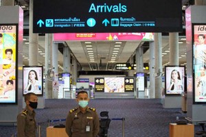 Immigration officers stand in front of an arrivals hall at Suvarnabhumi airport (Source: Reuters)