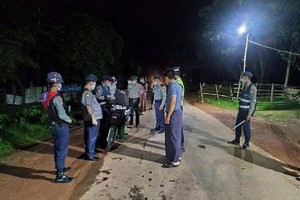 Police check a motorcycle in Yangon, Myanmar on 3 September after a curfew was imposed to prevent the spread of COVID-19. (Photo: gnlm.com.mm)