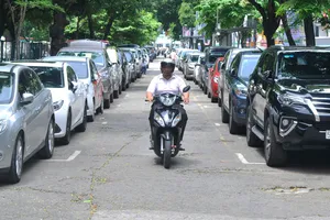 Không có bãi đậu xe ngầm nên ô tô phải đậu phía trước Công viên Lê Văn Tám.  Ảnh: THÀNH TRÍ