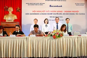 Ký kết cung ứng vốn giữa ngân hàng và các hộ kinh doanh, tiểu thương          Ảnh: HUY ANH