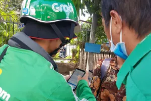 Một đối tượng giả danh GrabBike đứng đón khách tại Bến xe miền Đông  (quận Bình Thạnh, TPHCM)