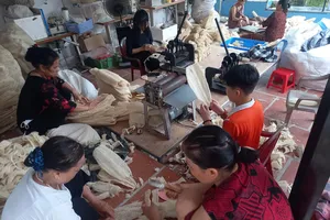 Anh Tạ Quý Tôn (ảnh nhỏ) và xưởng gia công và sản xuất xơ mướp tạo việc làm cho người lao động địa phương
