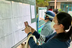 Phụ huynh xem danh sách học sinh lớp 1 tại Trường Tiểu học Phan Đăng Lưu (quận 8, TPHCM) sáng 1-8. Ảnh: CAO THĂNG