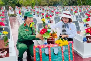 Bà Tân Thị Ngọc Bích (bên trái) và nữ hội viên chuẩn bị lễ vật cúng trước khi thực hiện nghi thức cất bốc, di dời hài cốt liệt sĩ