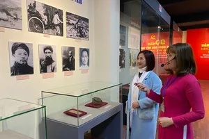 Hướng dẫn viên giới thiệu với khách tham quan triển lãm. Ảnh: QĐNDO
