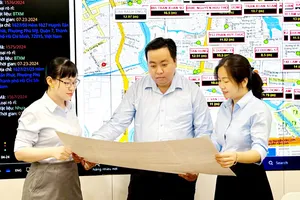 Kỹ sư Nguyễn Minh Hoàng (giữa), Công ty CP Cấp nước Nhà Bè, cùng đồng nghiệp nghiên cứu các cải tiến mới. Ảnh: THÁI PHƯƠNG