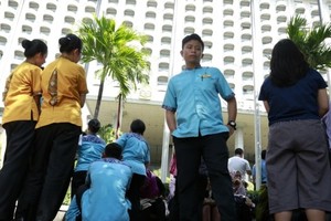 Employees gather as they evacuate from their hotel after an earthquake in Jakarta, Indonesia on Jan. 23, 2018 (Source: AP)