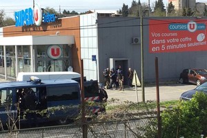 Police are seen at the scene of a hostage situation in a supermarket in Trebes, Aude, France on Friday in this picture obtained from a social media video. — REUTERS