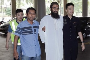 Salah Salem Saleh Sulaiman (second, right) became the first person to be convicted under Malaysia’s new anti-fake news law (Photo: AP)