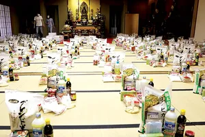 Các tình nguyện viên chuẩn bị nhu yếu phẩm cho người đến tá túc ở chùa Nisshinkutsu. Ảnh: Reuters