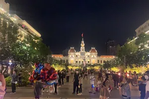 Người dân dạo phố chờ đón giao thừa. Ảnh: CHÍ THẠCH 