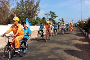 在平順省富貴島縣騎車動員民眾節約用電。
