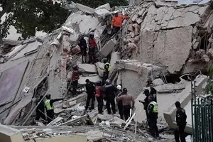 在委内瑞拉加拉加斯，搜救人员在地震倒塌的建筑物中寻找遇难者。图：EL UNIVERSIAL。