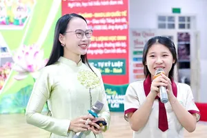 TS Nguyễn Thị Quốc Minh (trái) trong một buổi giao lưu, báo cáo chuyên đề về kỹ năng sống với học sinh.