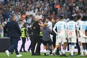 Các cầu thủ Marseille ngăn cản xô xát giữa nhân viên an ninh sân Velodrome và Lucas Beraldo phía PSG. Ảnh: RMC Sport