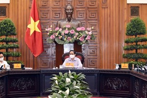 Prime Minister Pham Minh Chinh is delivering his speech in the meeting with MIC. (Photo: SGGP)