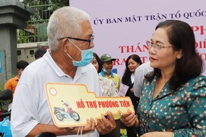 Chairwoman of the HCMC People’s Council Nguyen Thi Le is delivering a means to make a living to poor people (Photo: SGGP)