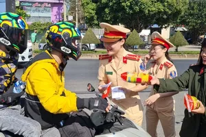 The police force of Buon Ma Thuot City are giving free water and bread to scooter riders returning home for Tet